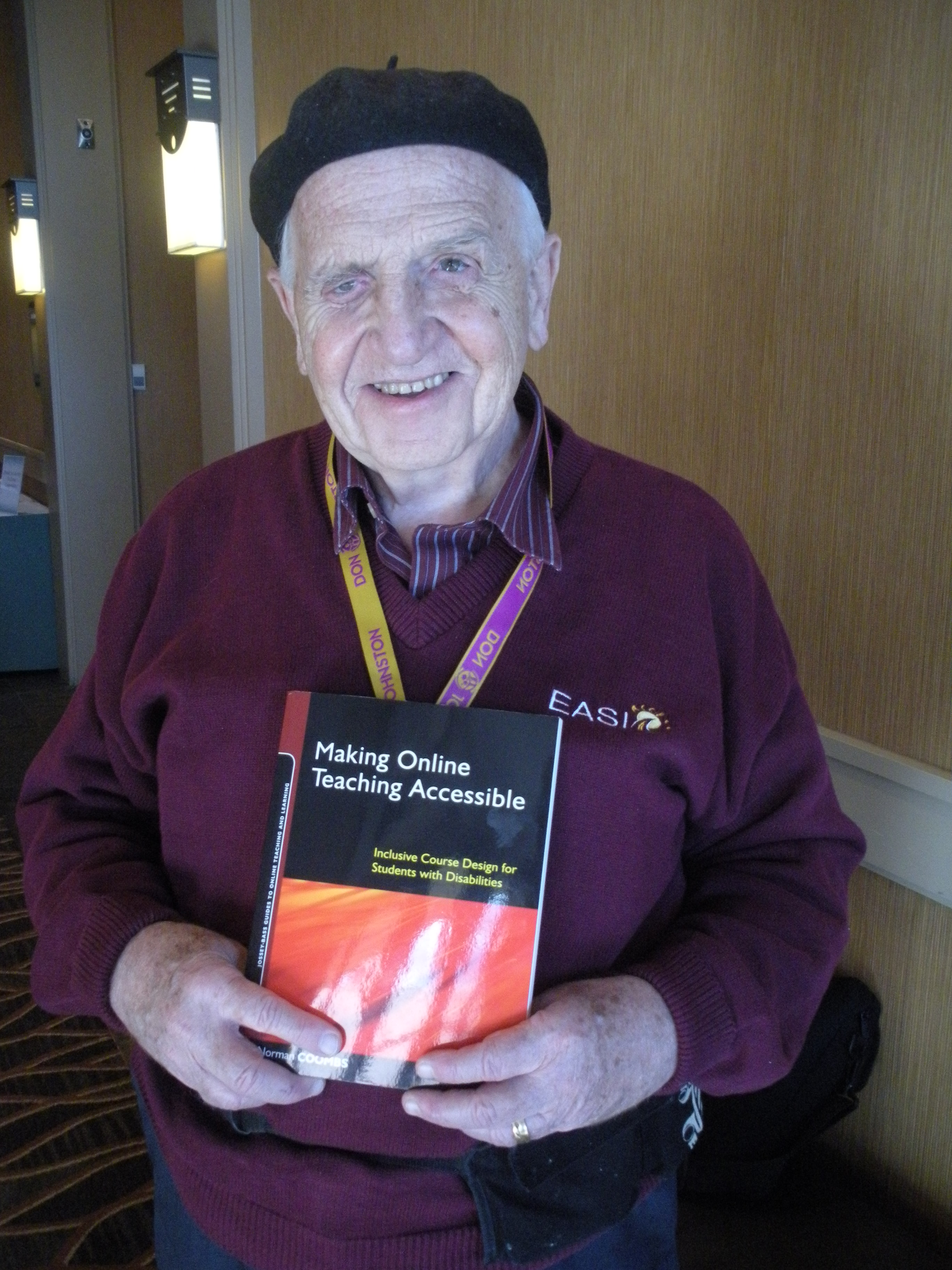 Dr. Coombs holding his new book, 'Making Online Teaching Accessible'