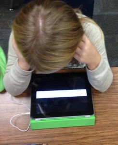 Student reading on a technology device.