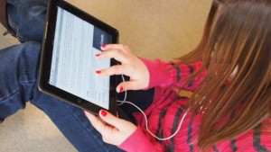 Girl reading with a tablet