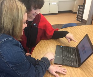 Photo of Michelle Thomas and Teacher, Deb Bolger at a laptop computer.