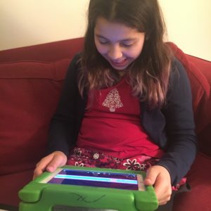 Paloma reads an accessible ebook from the Bookshare library on her iPad