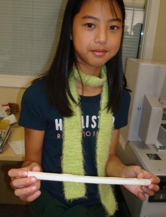 The 6th grade volunteer holding a spine.
