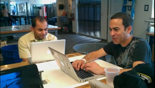 Bookshare's engineers, Rom and Gerardo, working on Macintosh laptops at the International Space Apps Challenge