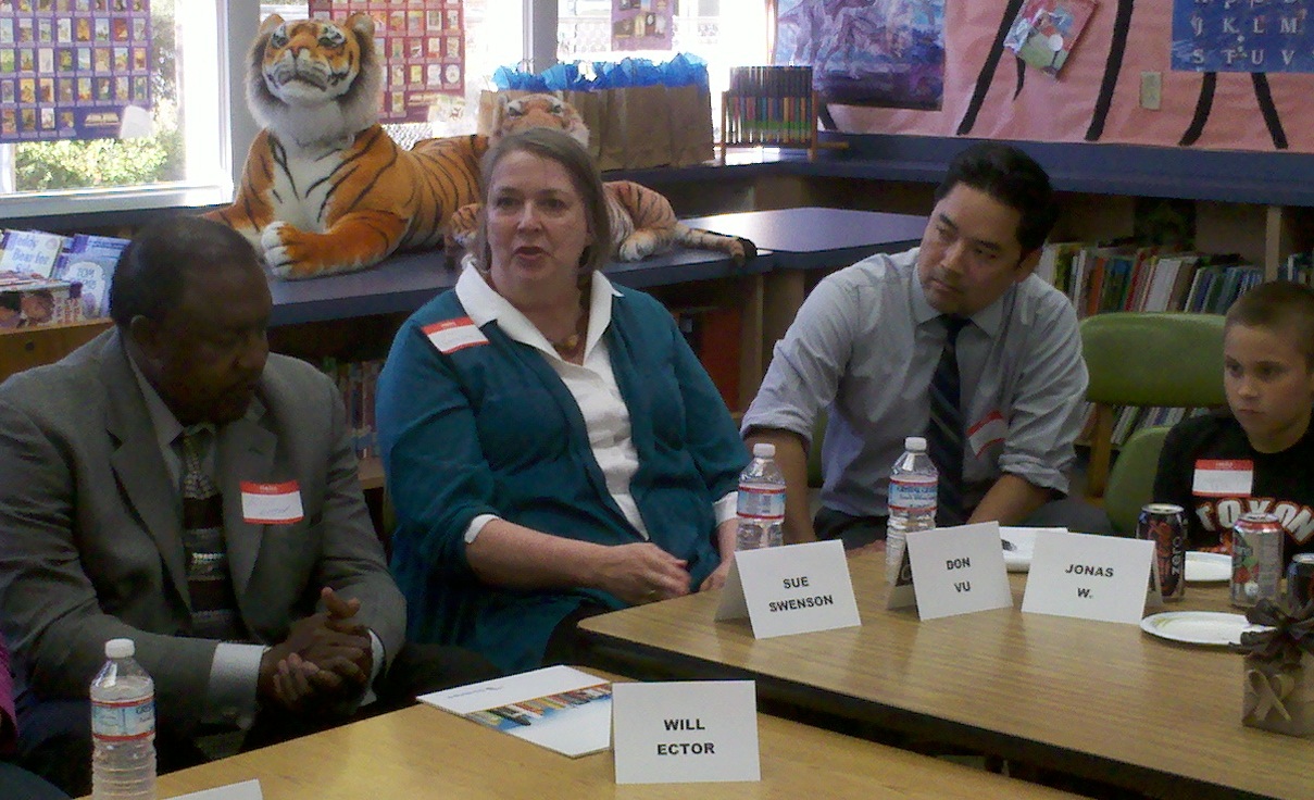 Sue Swenson talking with Will Ector, Superintendent, and Don Vu, Principal with one of the students listening. 