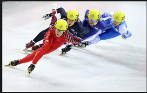 Speed skaters racing on the ice.