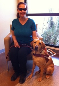 Image: Bookshare Customer Support Specialist, Angela Griffith with her guide dog, Summer.