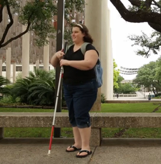 Amber, a college student, who is blind, walks on her college campus to class.
