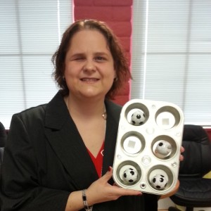 Allison Hilliker demonstrating how she teaches braille using a muffin tin and balls 