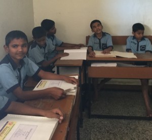 Young boys with visual impairments sitting at desks in a classroom in India in India