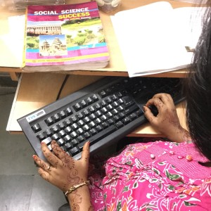 Adult student in India reading an accessible ebook on a computer