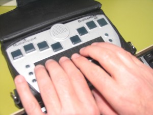 Photo of hands on a BrailleNote device