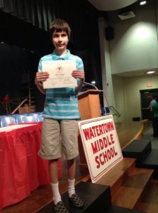 Rosdom receiving a Presidential Award at eighth grade graduation. This award is given to students with As in all classes for all three years.