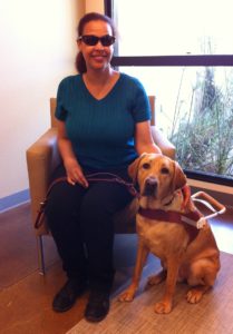 Angela Griffith, Technical Support Specialist, and her guide dog, Summer