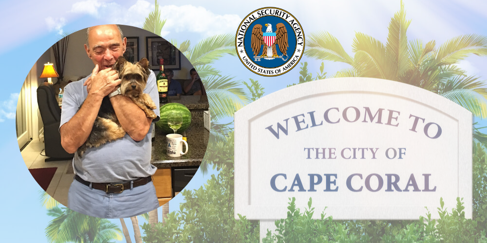 Bernie Perella holds his dog next to a sign that says 'Welcome to the city of Cape Carol' and the seal of the National Security Agency